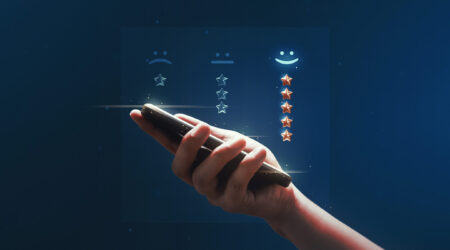 Hand holding review rating gold star sign or best excellent satisfaction five rate quality ranking success symbol on vote service rank background with like button and positive customer experience.