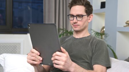 man using self-service on tablet for ticket deflection.