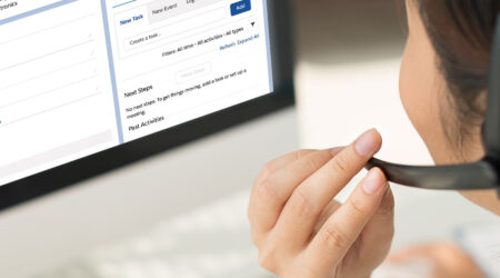 Woman looking at a computer in an office.