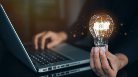 Person holding lightbulb with AI.