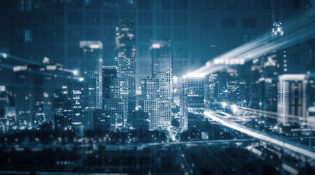 Futuristic cityscape with digital overlays representing smart city technology and connectivity.
