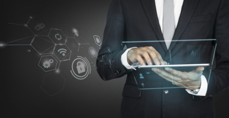 Businessman in a suit using a transparent digital tablet with futuristic icons floating around.