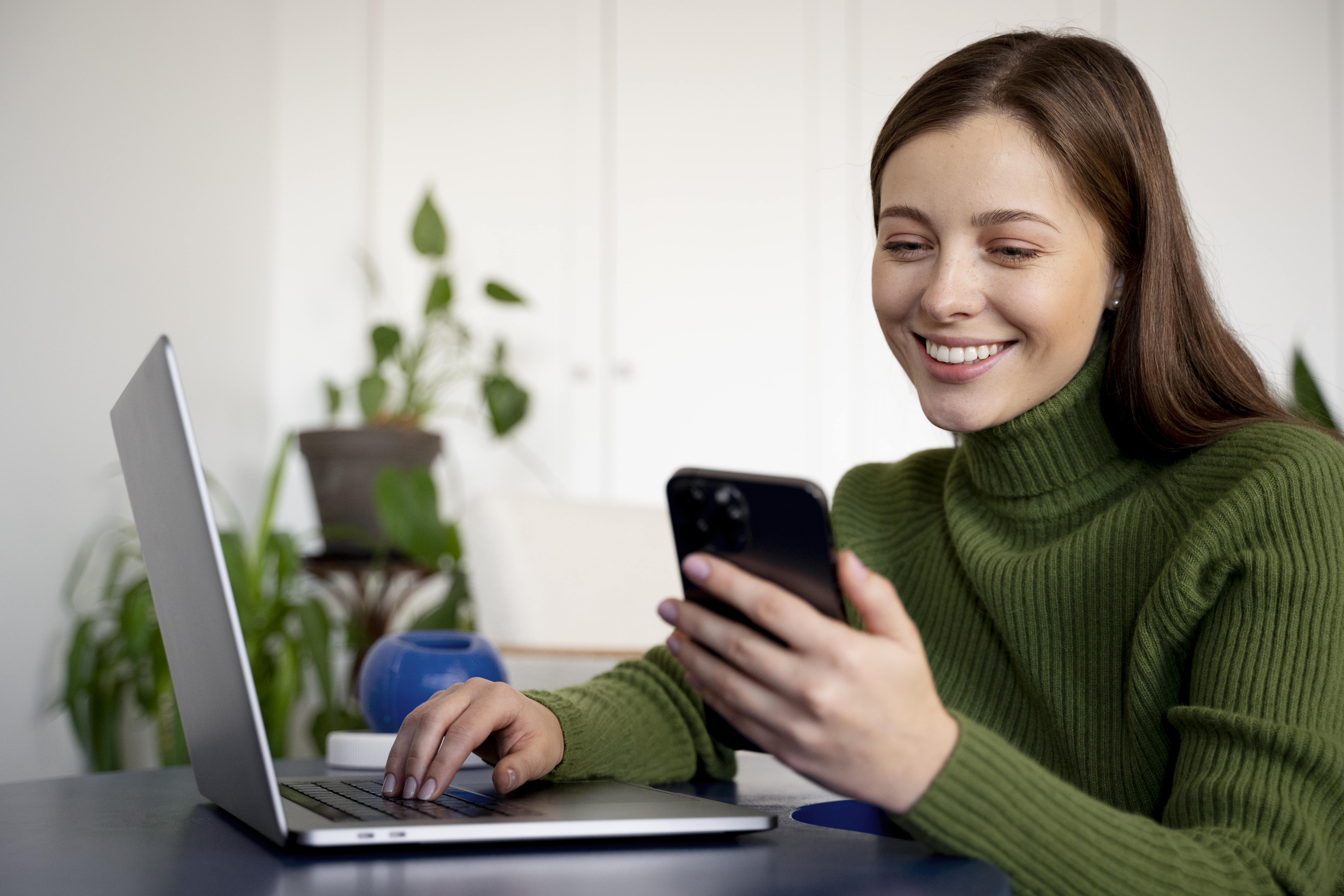 smiling customer looking at phone due to benefits of self service portal.