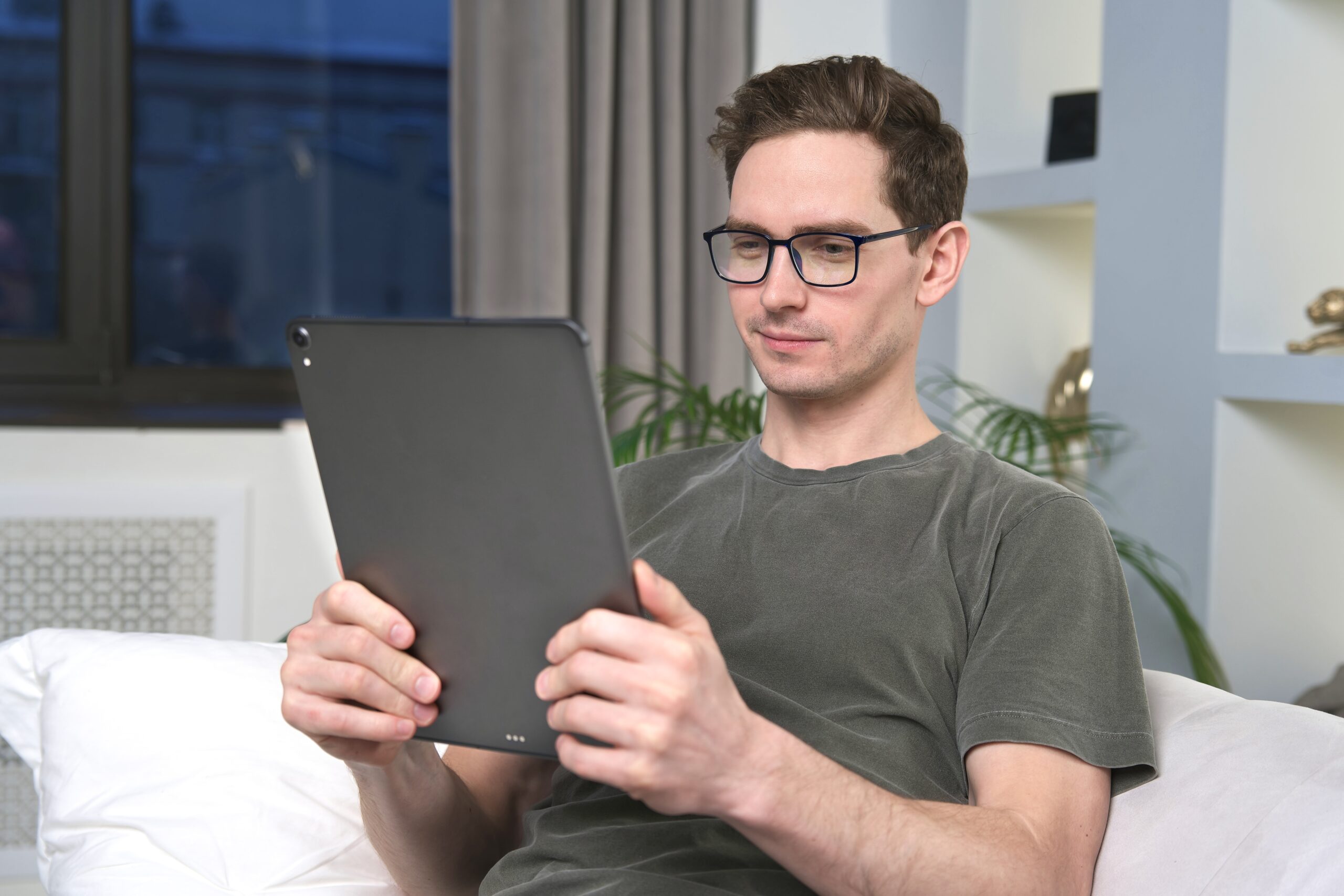 man using self-service on tablet for ticket deflection.