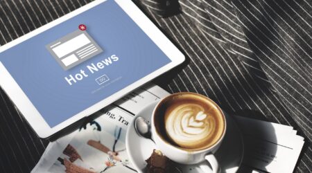 Hot news on tablet with coffee.