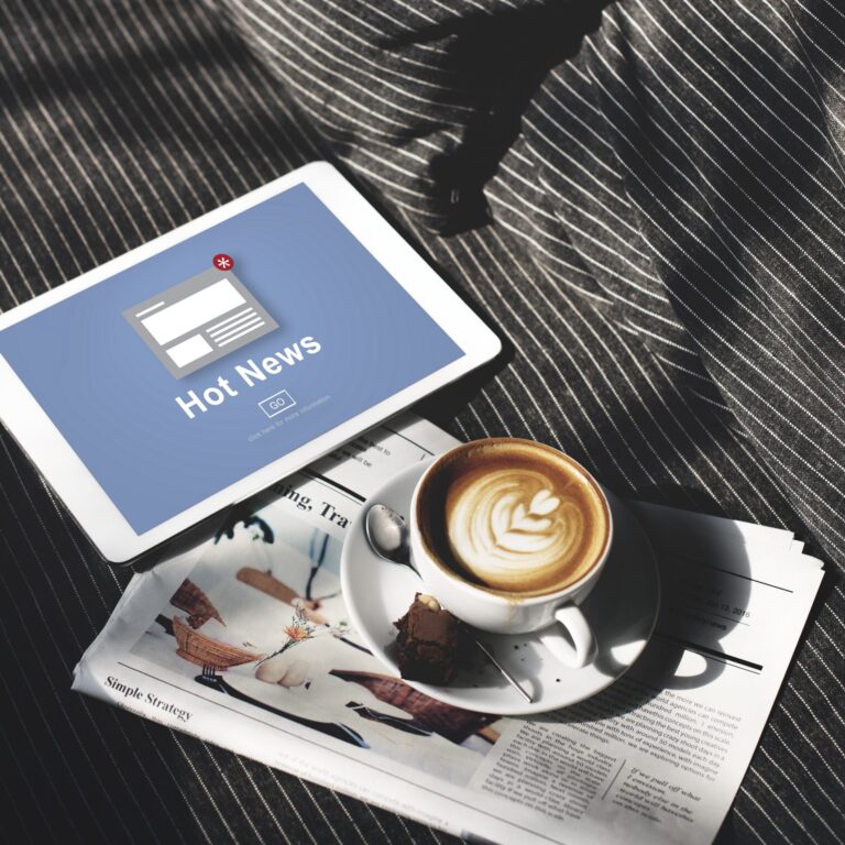 Hot news on tablet with coffee.