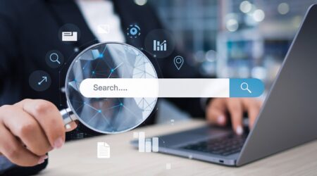 different data icons around search bar and person holding magnifying glass.