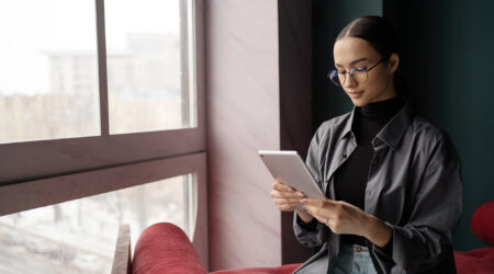 woman using tablet to reduce support tickets.