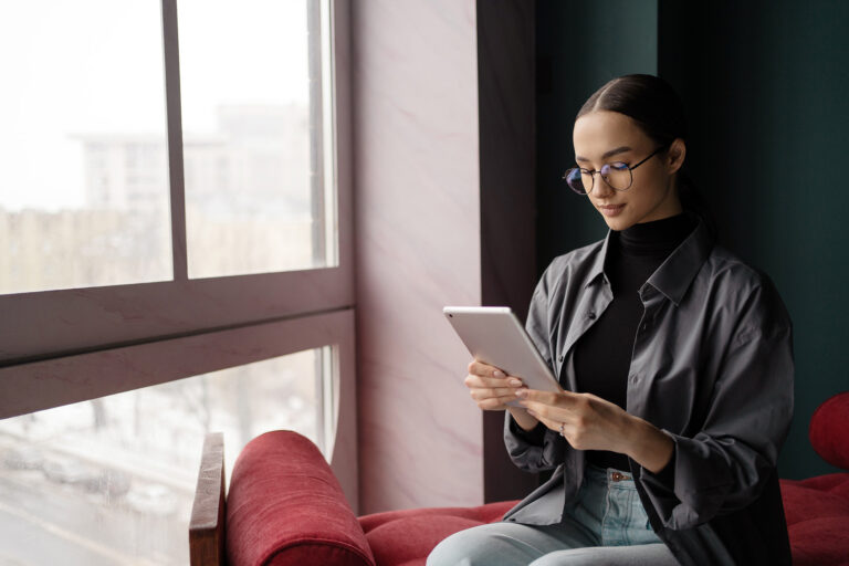 woman using tablet to reduce support tickets.