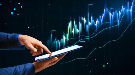 Person touching a tablet and a spending chart showing less spending and more growth over time.
