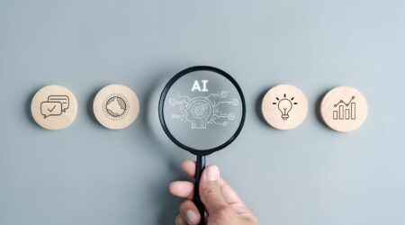 magnifying glass over AI with round tokens on both sides with analytics and messages and lightbulbs.