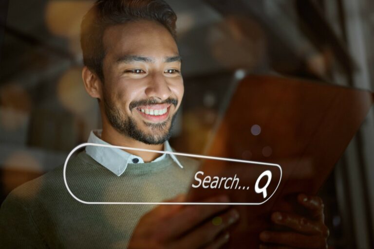 man smiling with tablet in hands and digital search bar overlayed.
