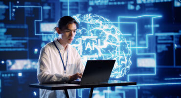IT worker on computer with digital screen behind him that says AI.