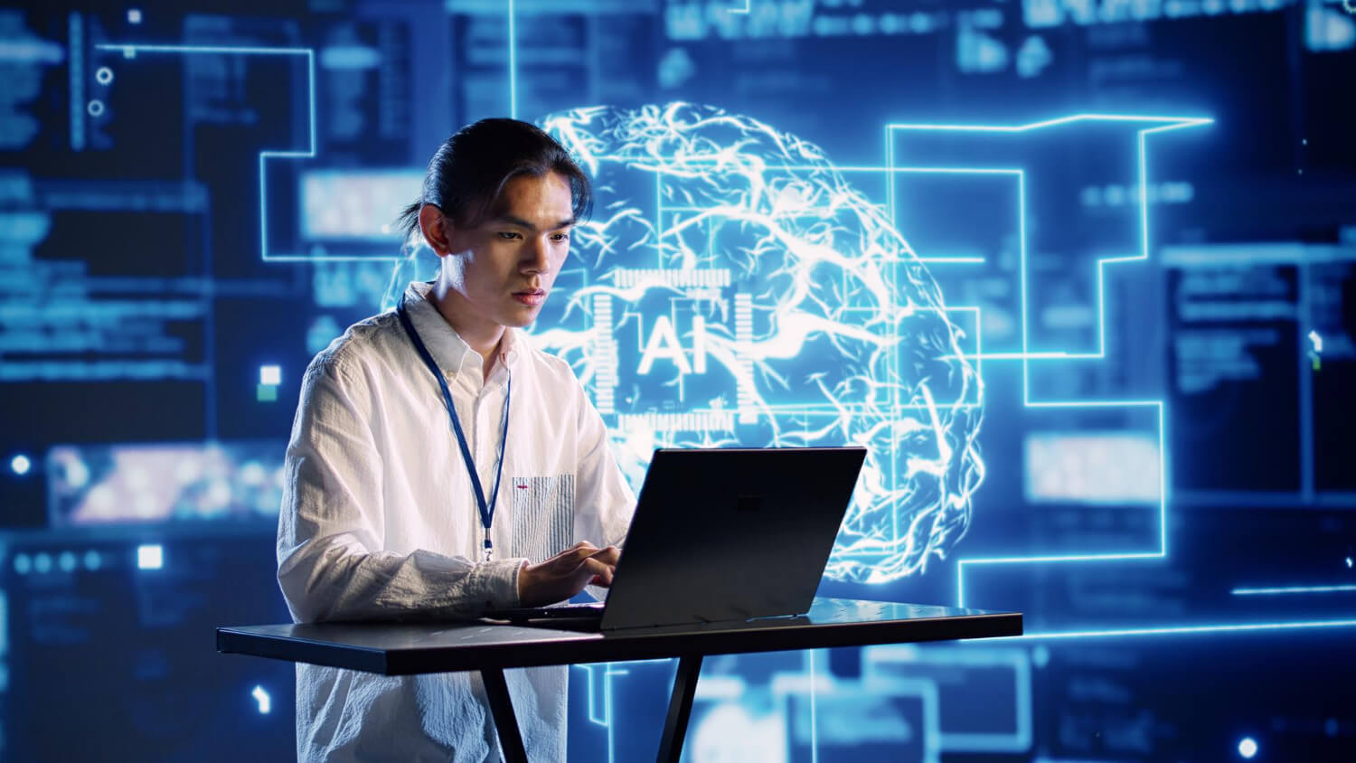 IT worker on computer with digital screen behind him that says AI.