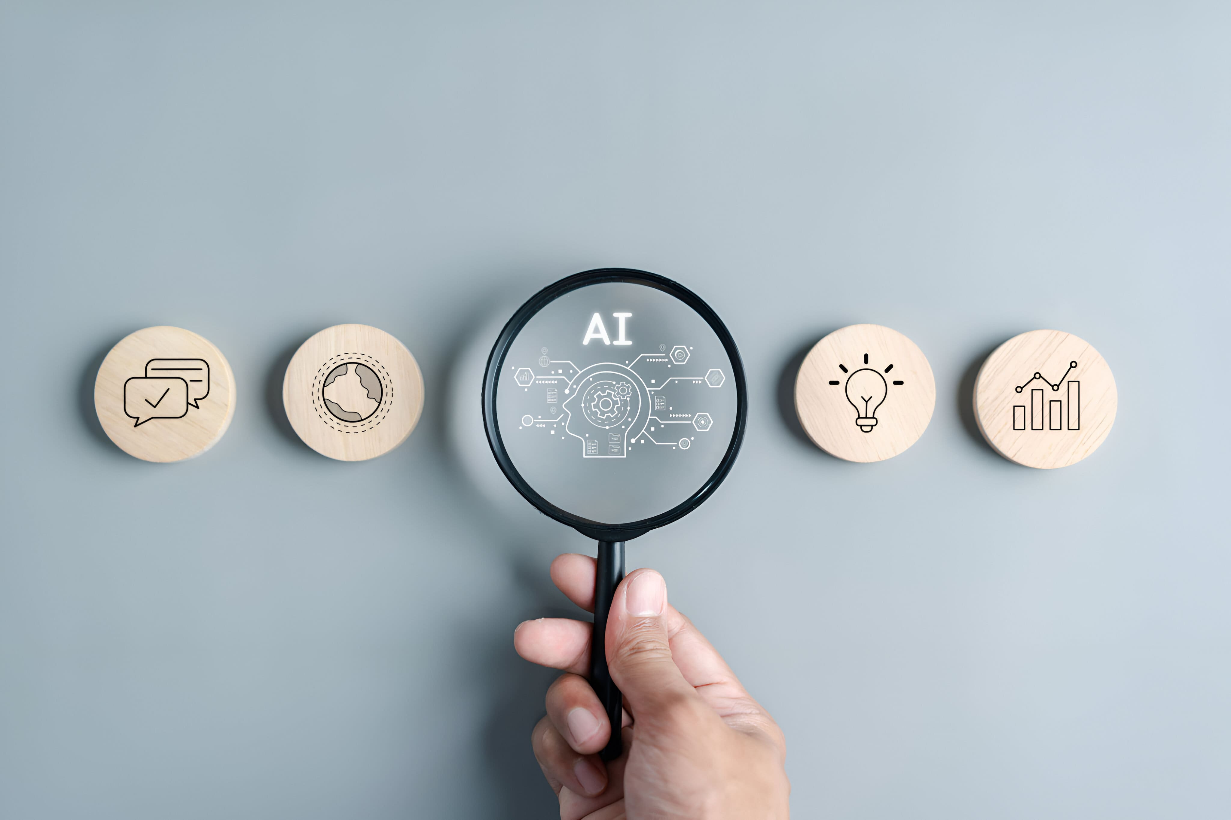 magnifying glass over AI with round tokens on both sides with analytics and messages and lightbulbs.