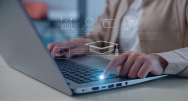 Digital icons of metrics, content, and learning systems over a person typing on laptop.